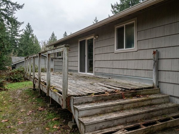 Worn pressure-treated deck before rebuild, example